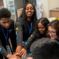 Group of Rep4 Students putting hands in middle of cirlce